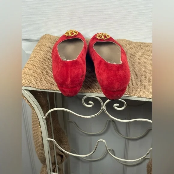 Salvatore Ferragamo red suede pumps featuring a gold-toned ornamental buckle